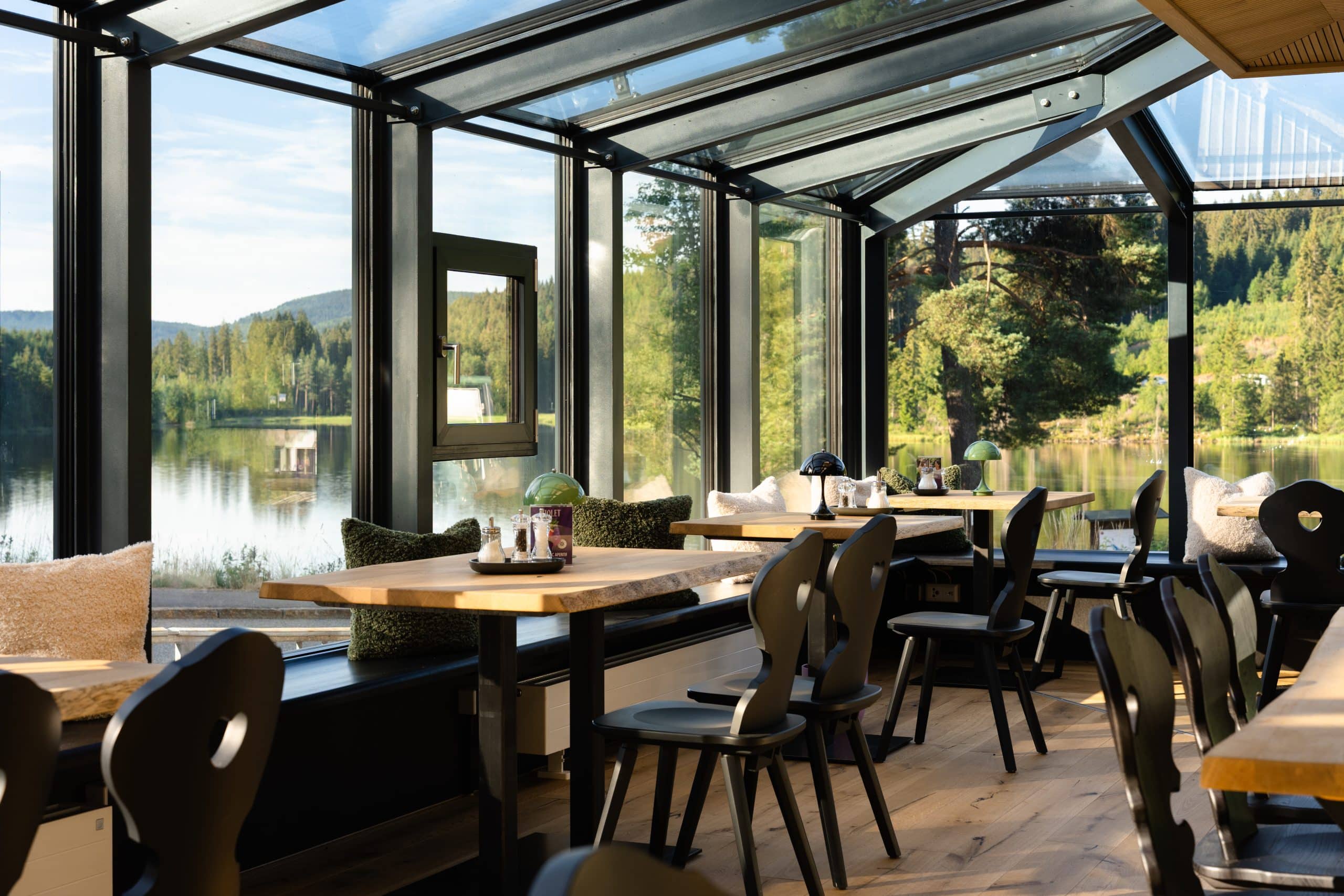 Restaurant tables overlooking the Windgfällweiher in the winter garden